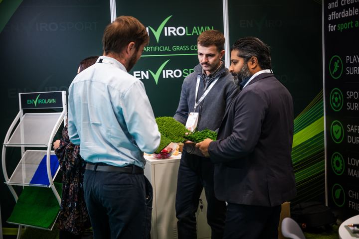 Showing artificial grass samples to visitors