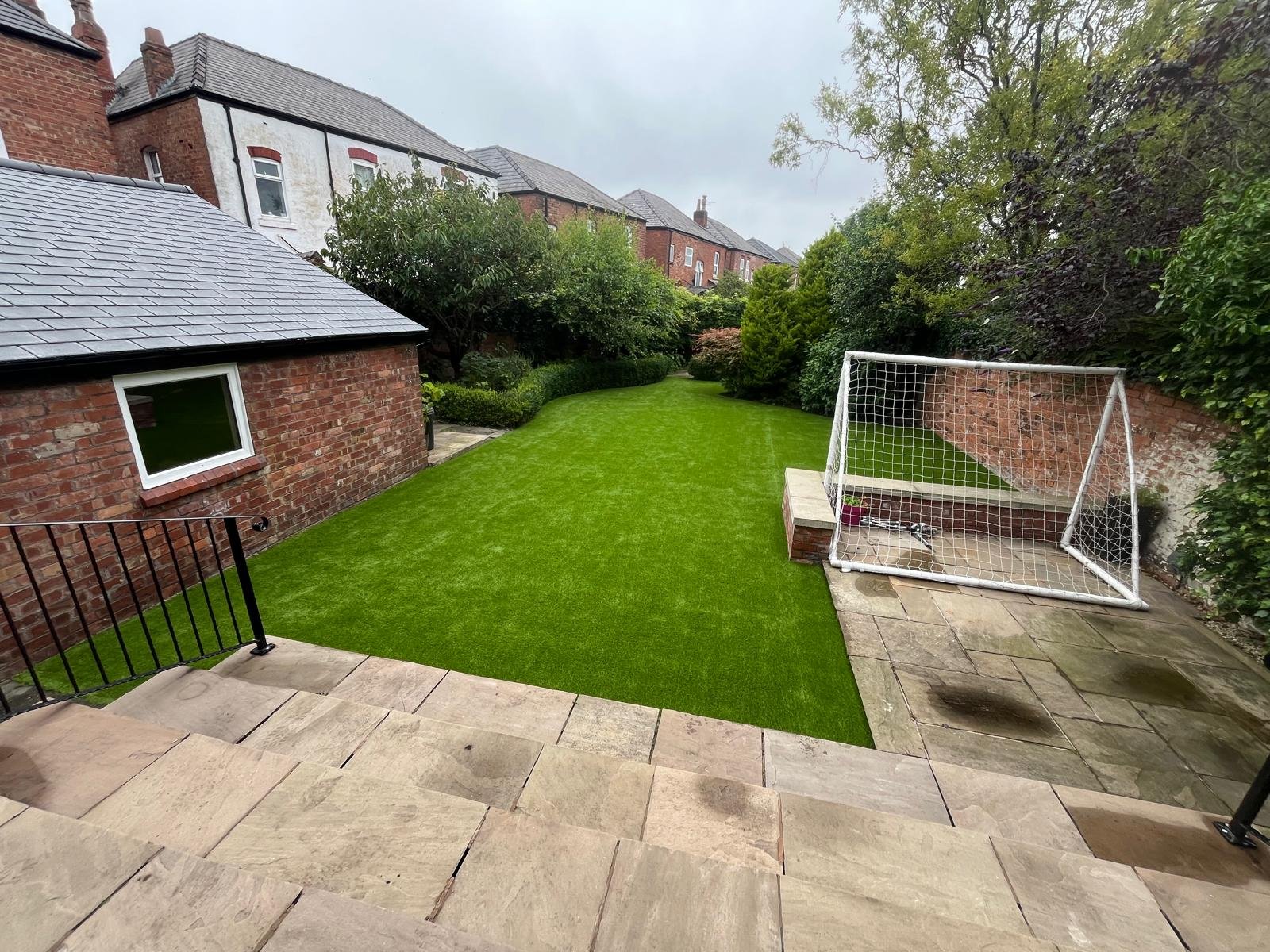 A garden artificial lawn with a football goal